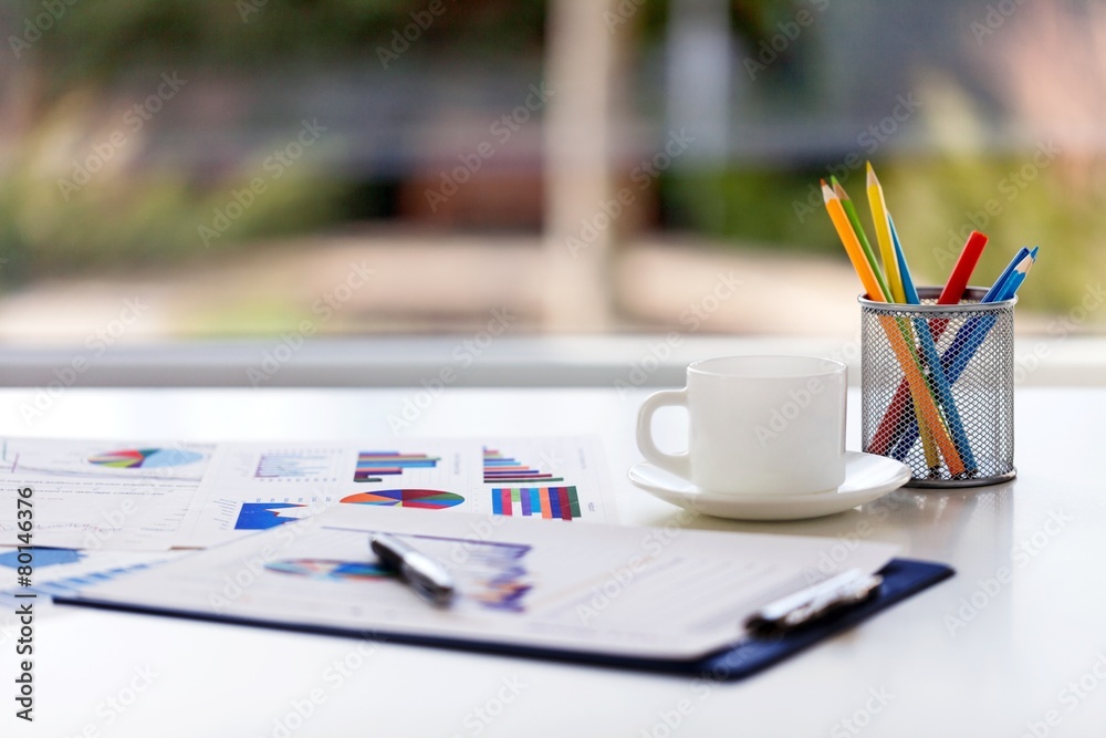 Desk. Close-up image of an office desk at morning with a cup of