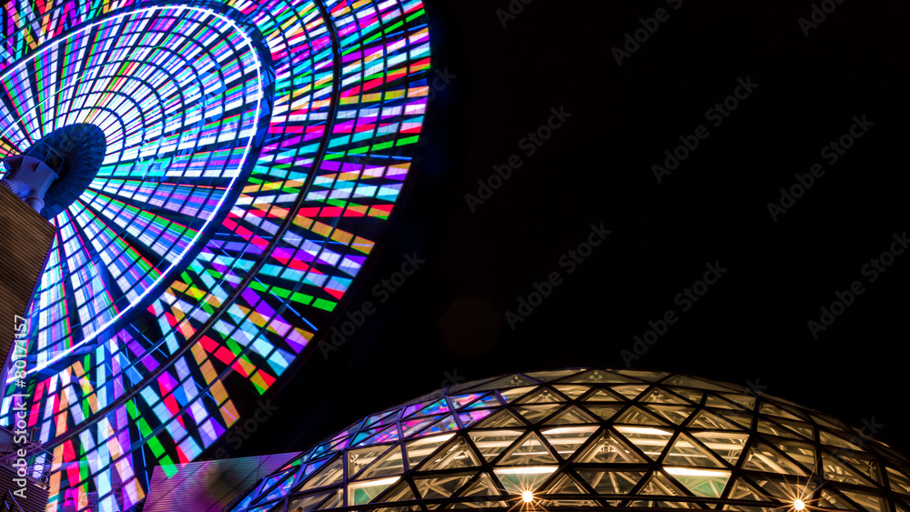 Lit Ferris Wheel Spinning Against Black Night Sky