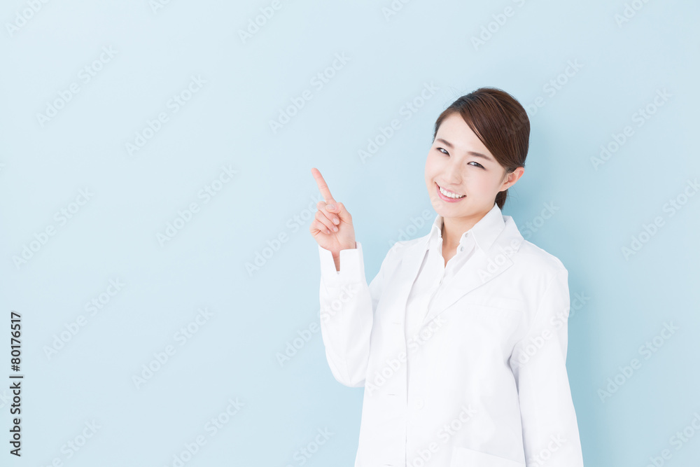 young asian doctor on blue background