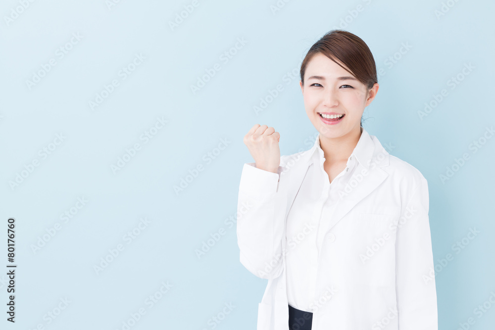 young asian doctor on blue background