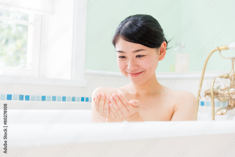 young asian woman relaxing in the bathroom