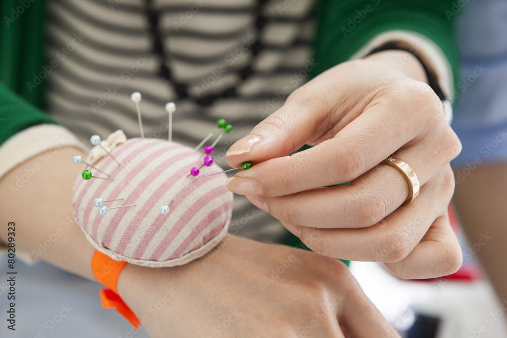 Woman pointing a dress pin