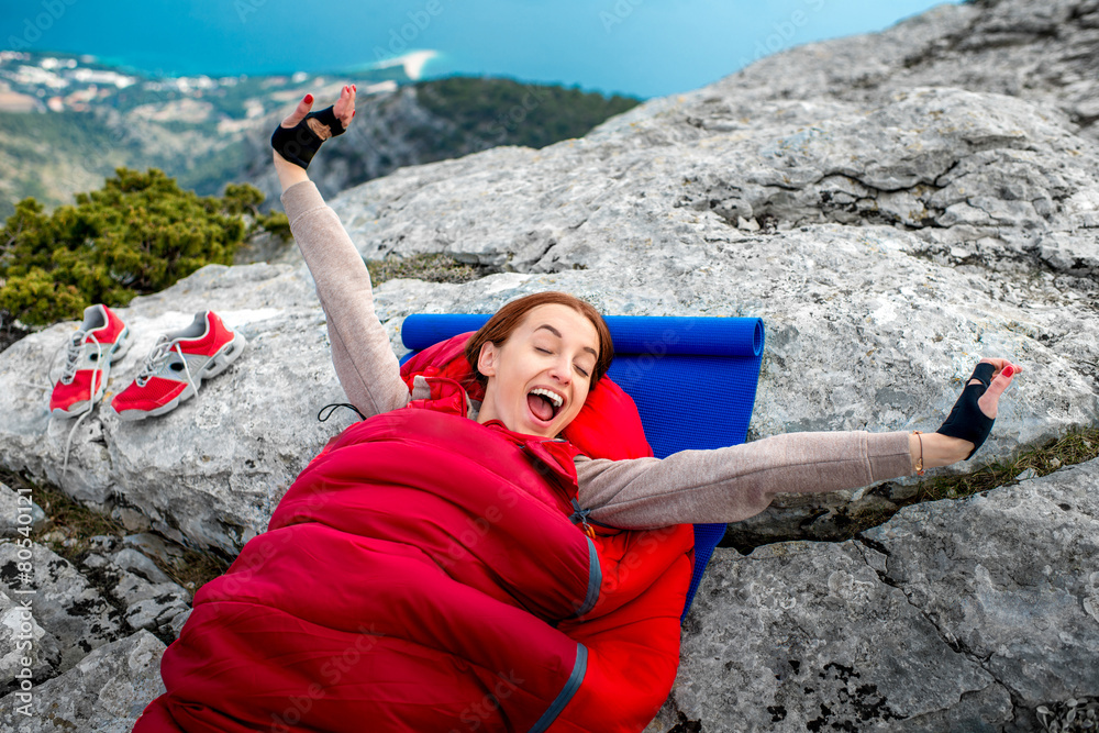 Woman in sleeping bag on the mountain