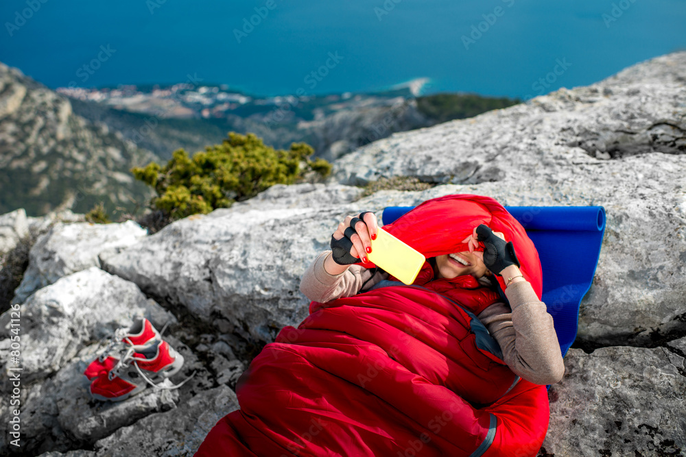 Woman in sleeping bag on the mountain