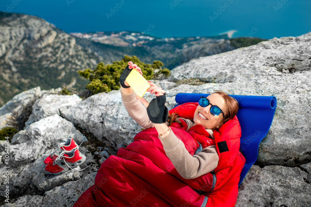 Woman in sleeping bag on the mountain