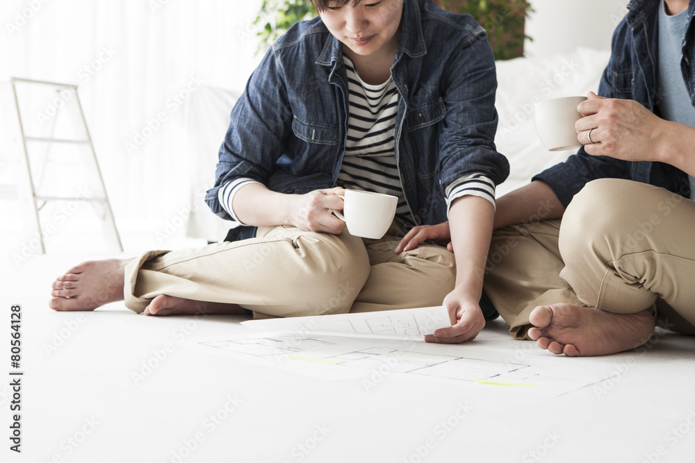 Young couple are talking while watching the floor plan