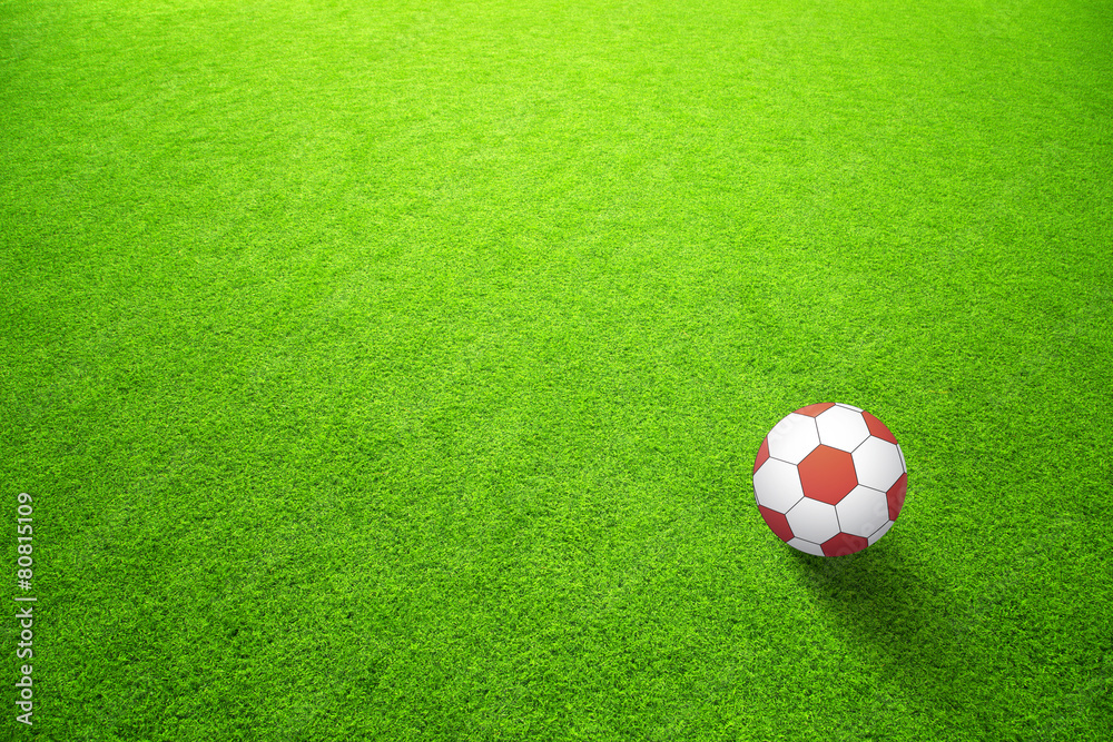 Artificial green soccerfield with red ball