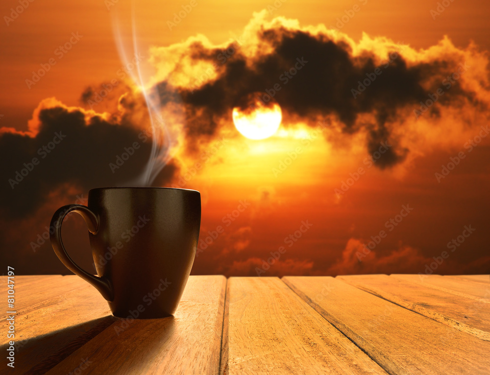 Morning cup of coffee with sunrise background