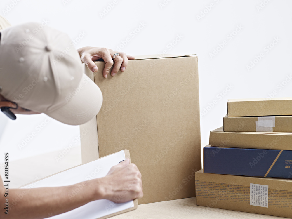 warehouse worker checking packages received