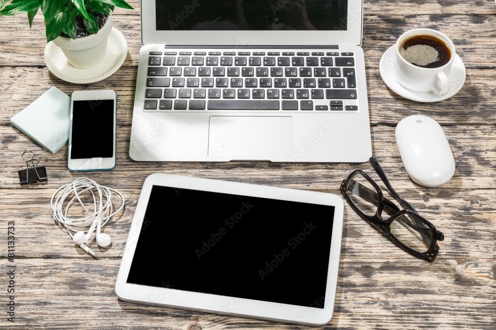 View. Laptop, smartphone, tablet and coffee cup with financial