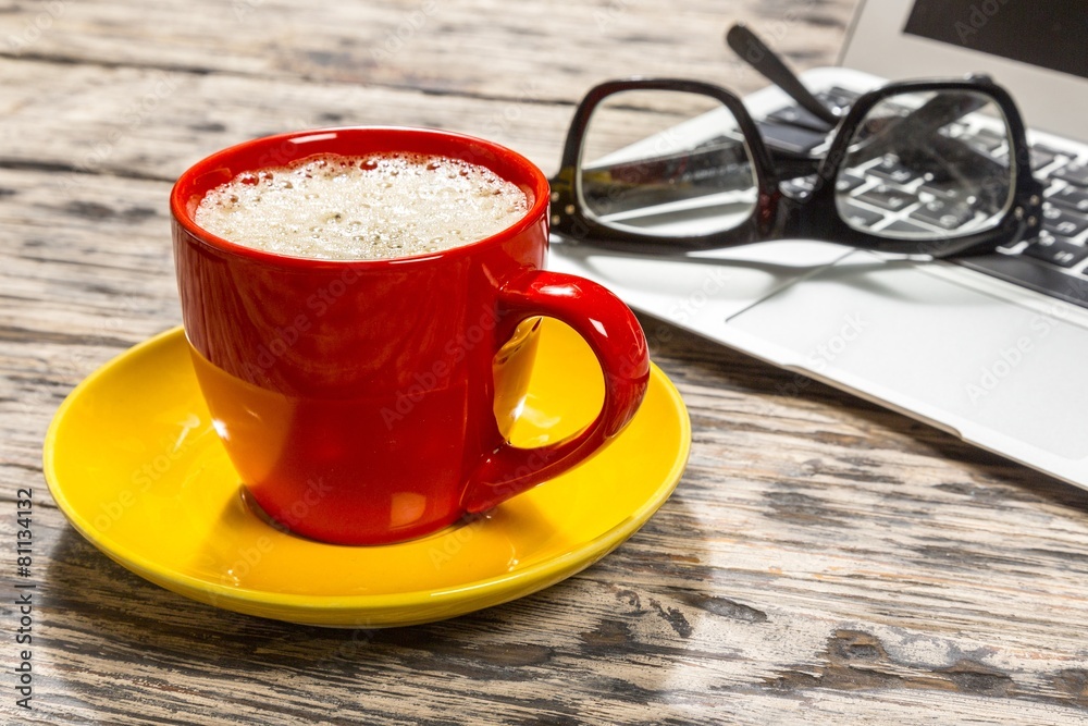 Glasses. Cup of coffee and laptop with a pair of hipster glasses