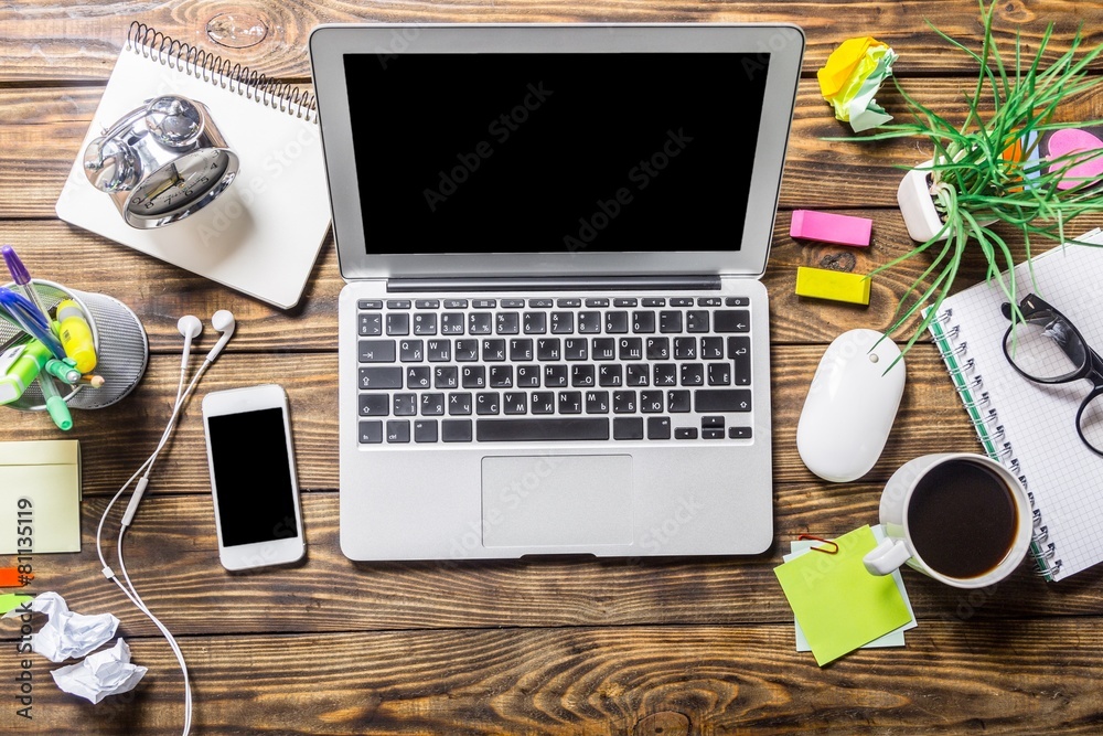 View. Mix of office supplies and gadgets on a wooden desk