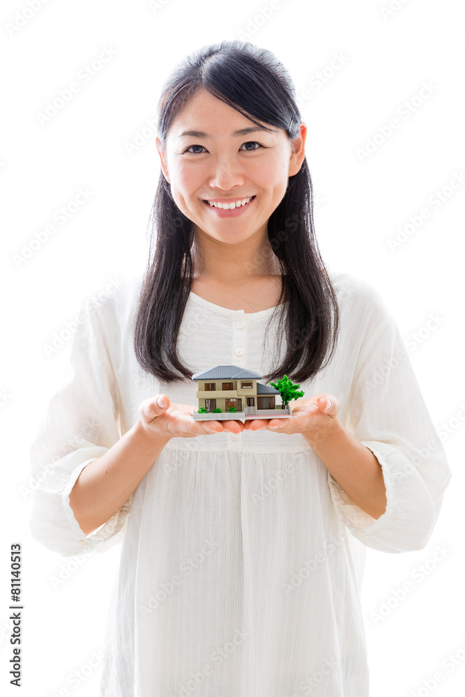 young asian woman with miniature house