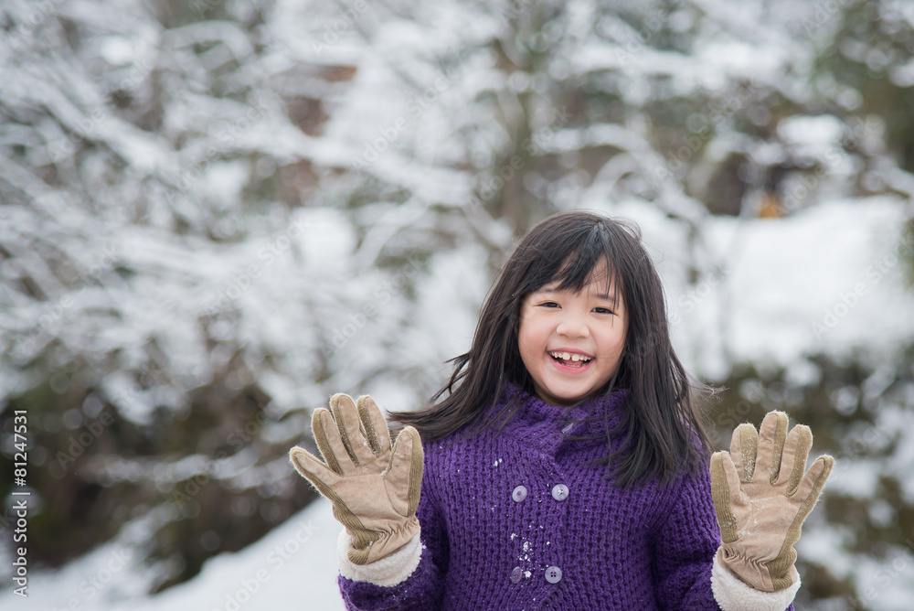 Cute asian girl smiling outdoors in snow