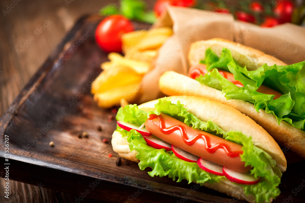 Hot dog. Grilled hot dogs with ketchup on a wooden table