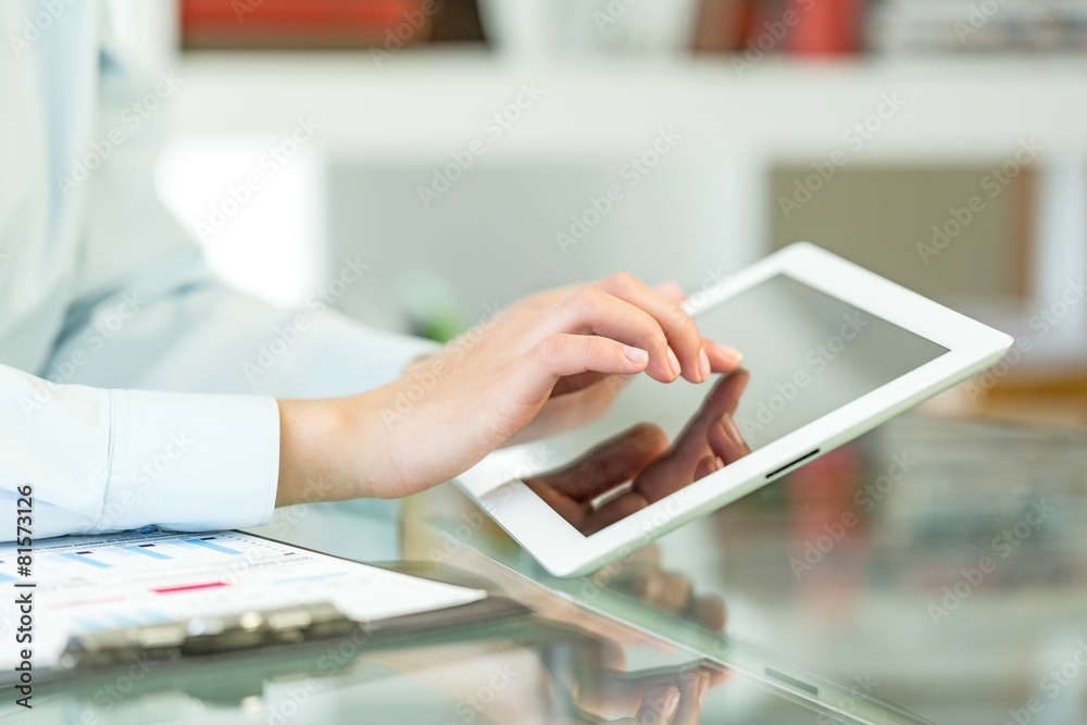 Tablet. Close-up of a female touching the screen of a tablet