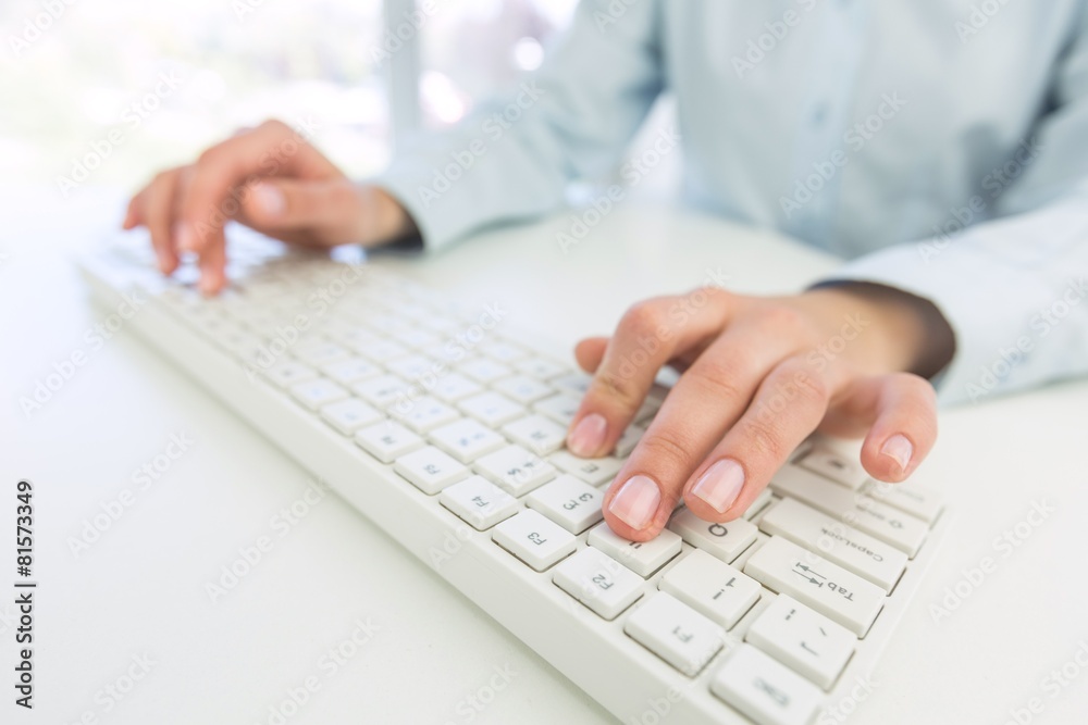 Network. Female office worker typing on the keyboard