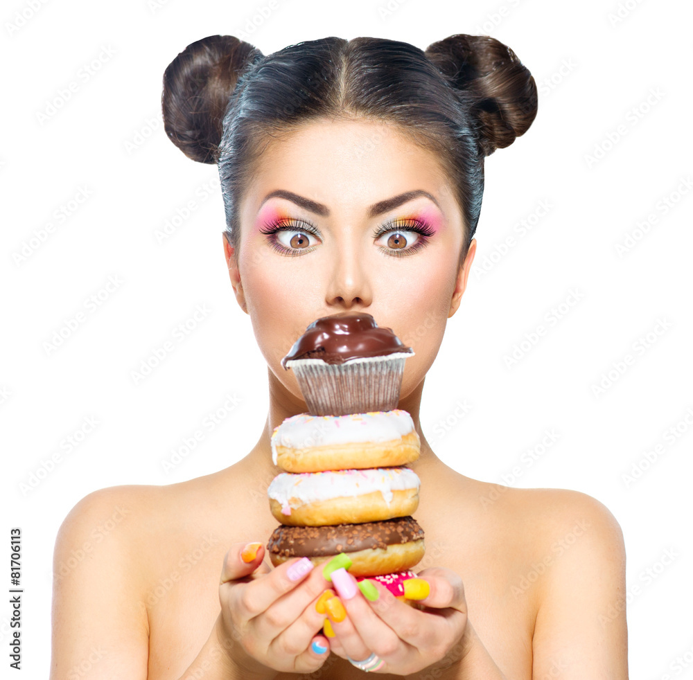 Beauty model girl taking stack of colorful donuts and muffin