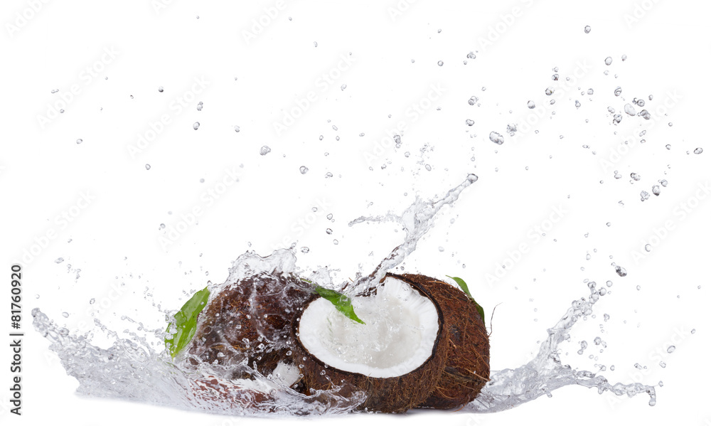 Cracked coconuts in water splash on white