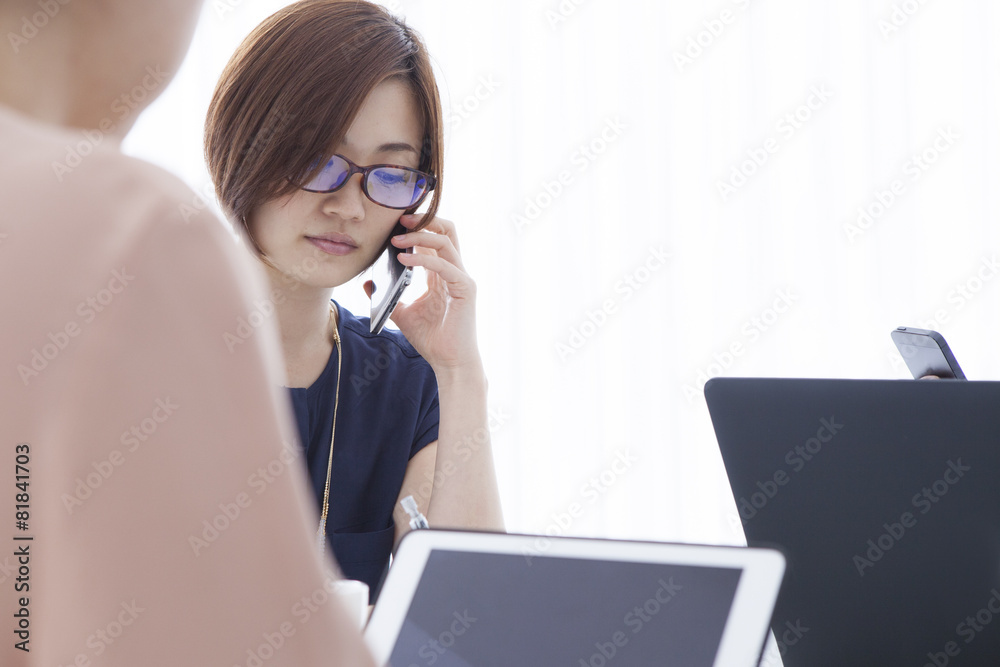 Women have a meeting by telephone.