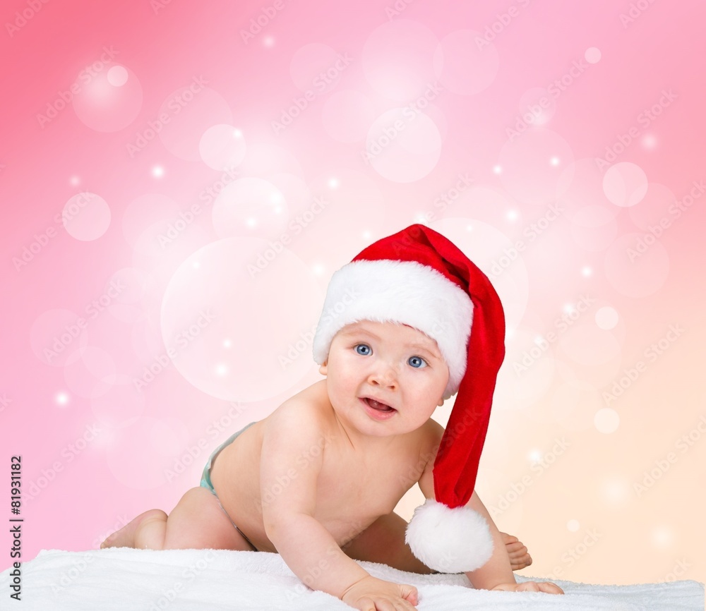 Infant. Little cute girl with santa hat on blue background