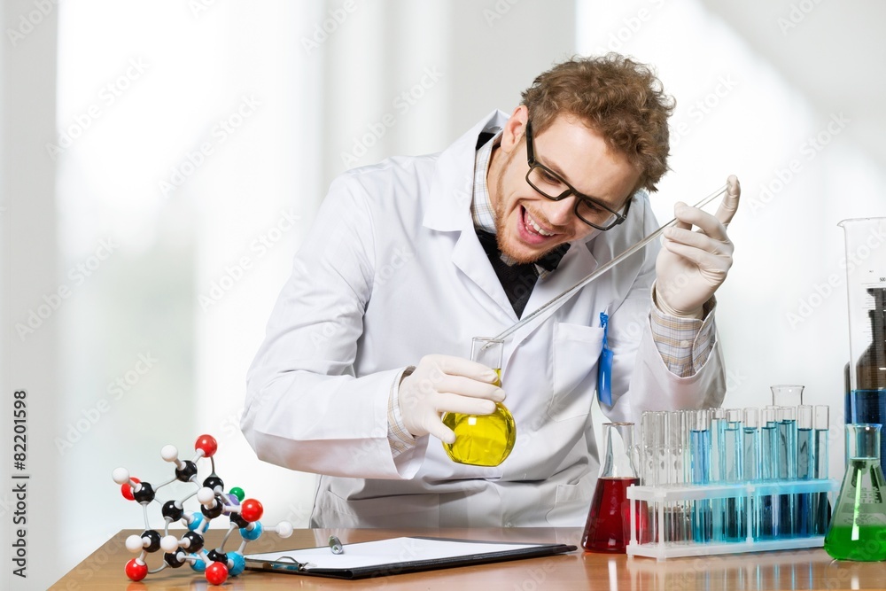 Scientist. Mad professor holds an experiment in his laboratory