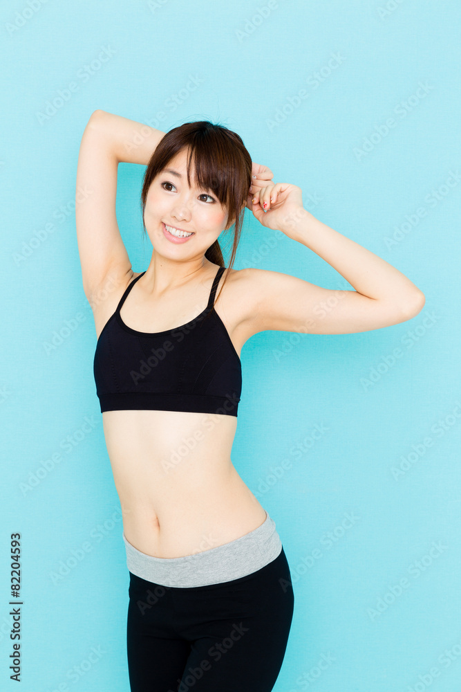 sporty asian woman on blue background