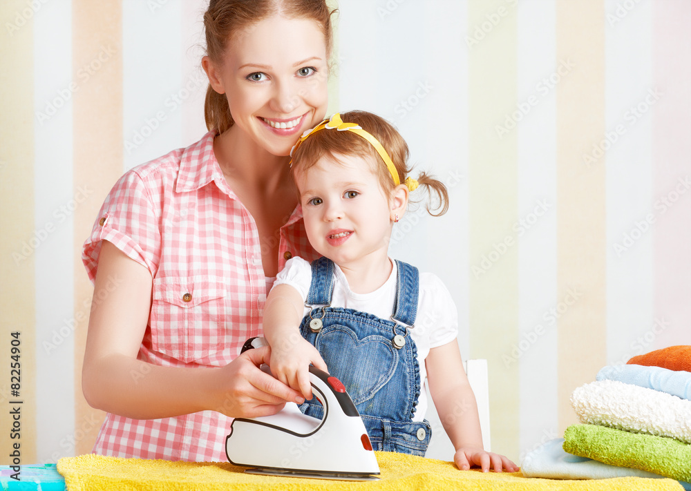 family mother and baby daughter together engaged in housework ir