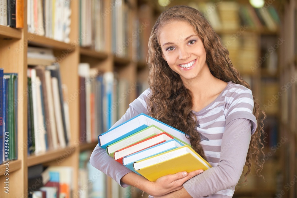 Student. Pretty Female Student Surrounded by Library Books