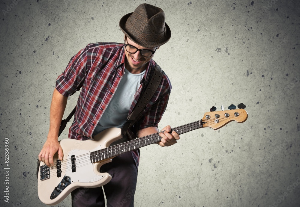 Art. Rock musician is playing electrical guitar.