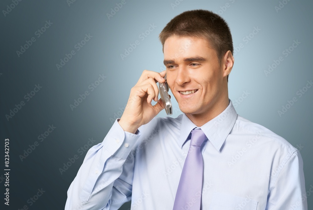 Mobile Phone. Attractive Young Businessman On Cellphone