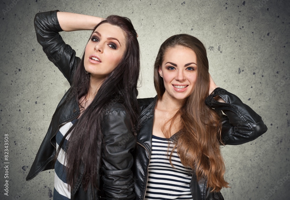 Attractive. Two young girl friends standing together and having