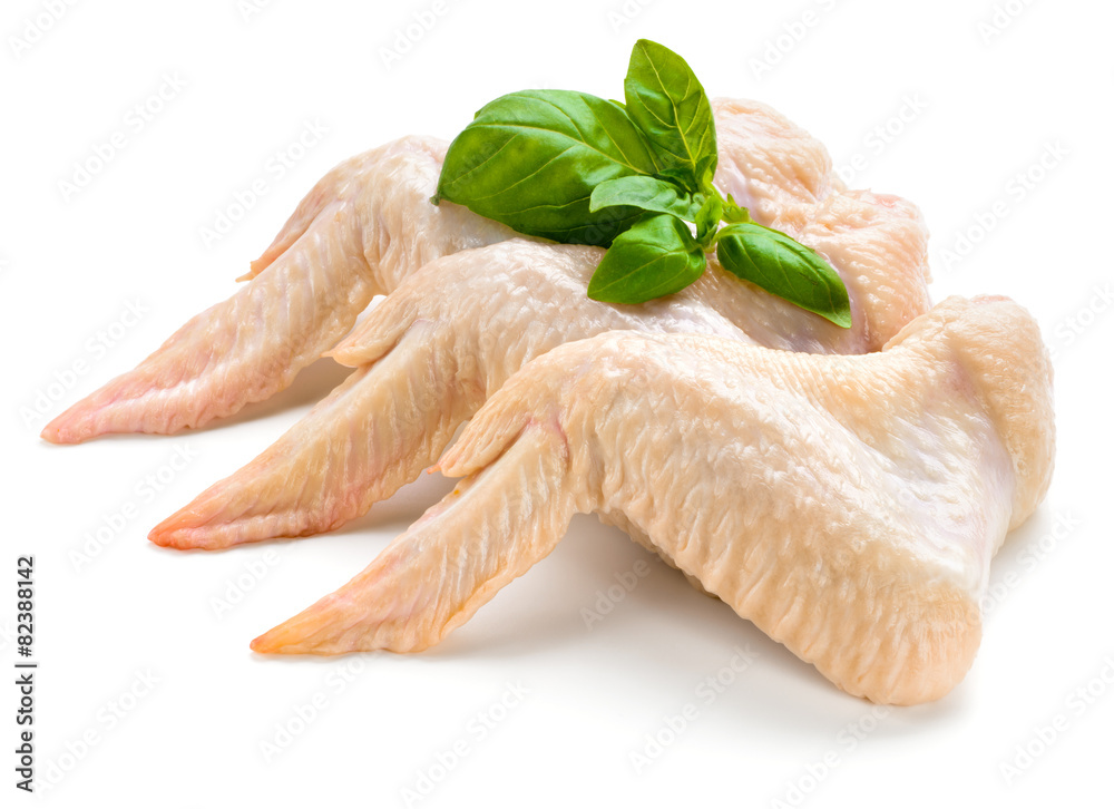 Raw chicken wings with basil isolated on white background