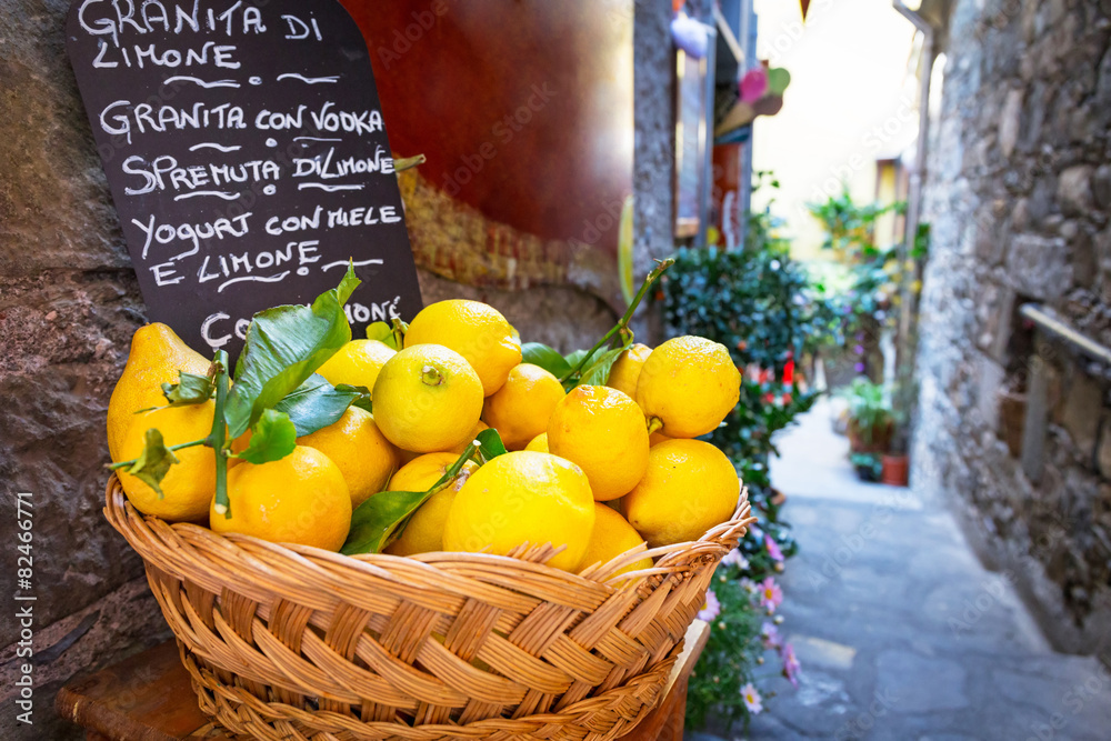 Wicker basket full of lemons on the italian street od Corniglia