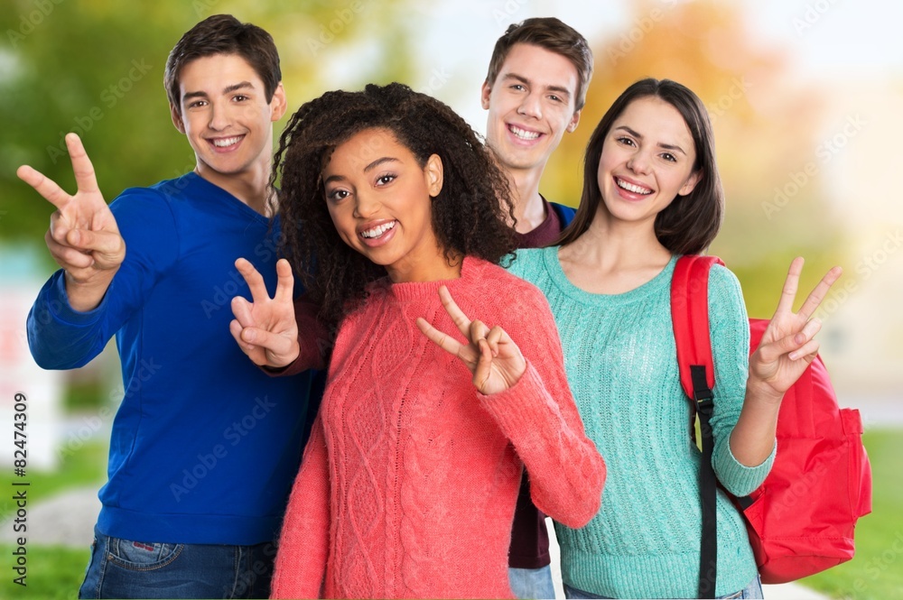 Achievement. Happy Young students Showing Victory Sign