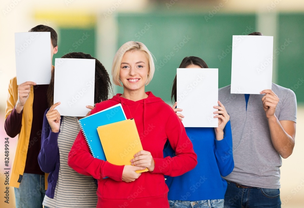 Question. Woman Standing In Front Of Friends Holding Paper With