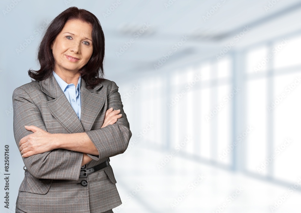 Women. Close-up of businesswoman smiling with arms crossed