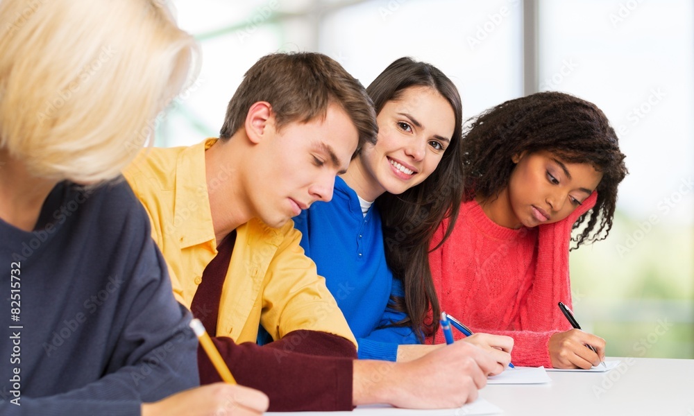 Schooling. Students writing at high-school exam teens study