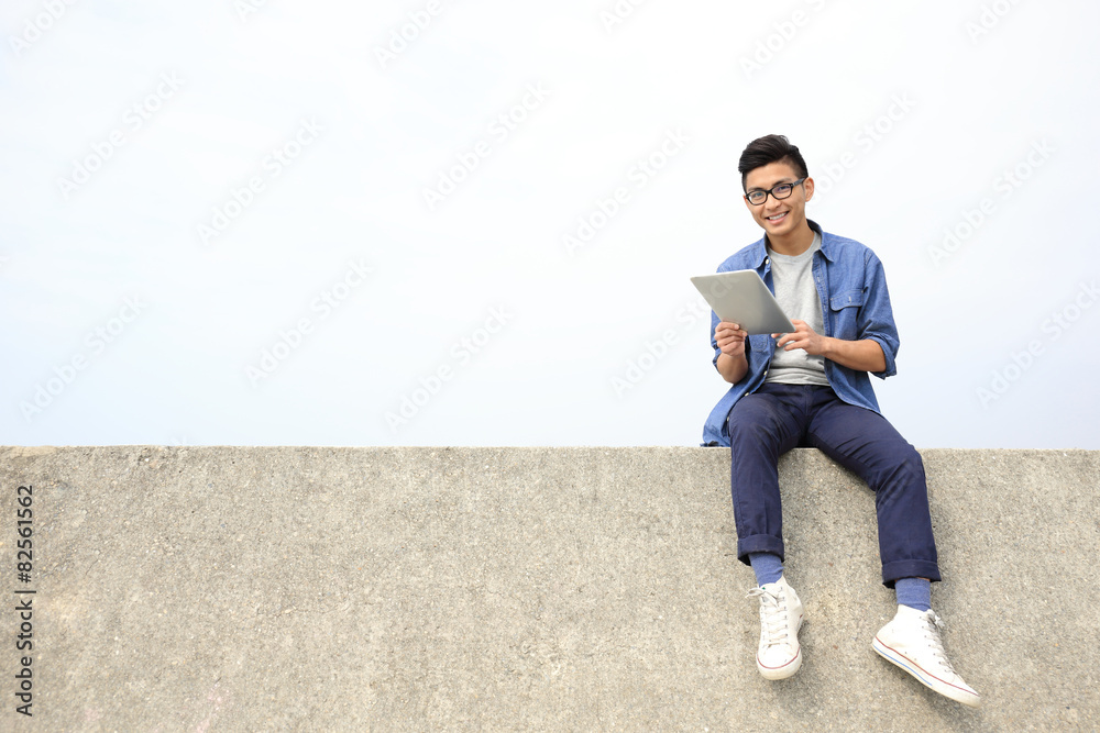 Happy man using digital tablet