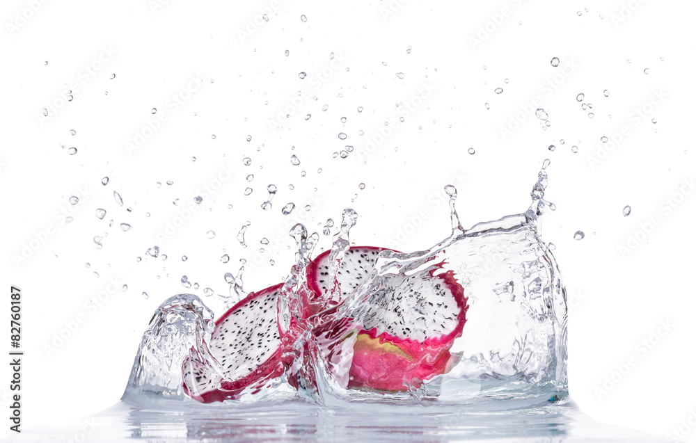 Fresh dragon fruit in water splash on white