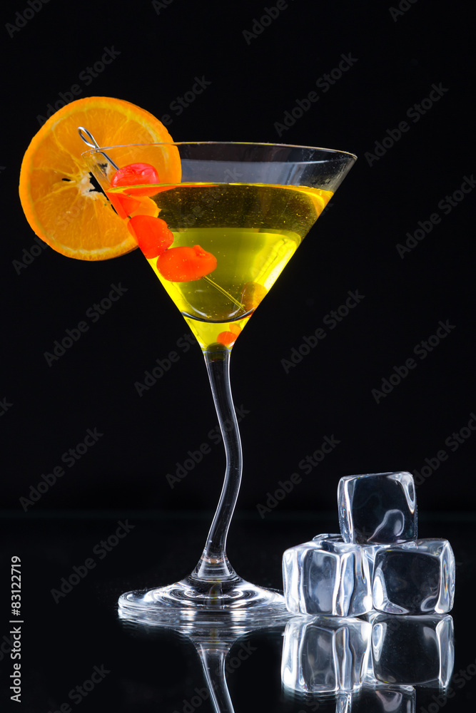 Martini drink served on glass table with ice cubes