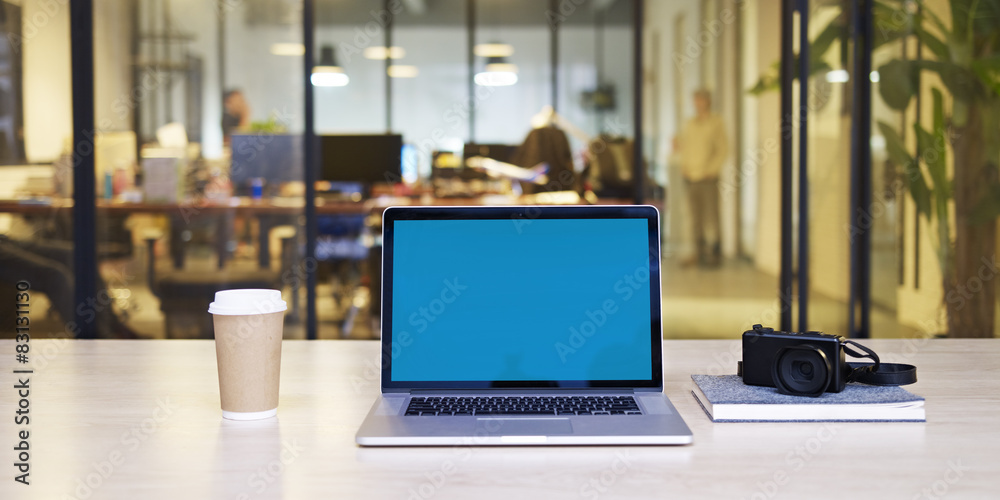 laptop with blue screen in office