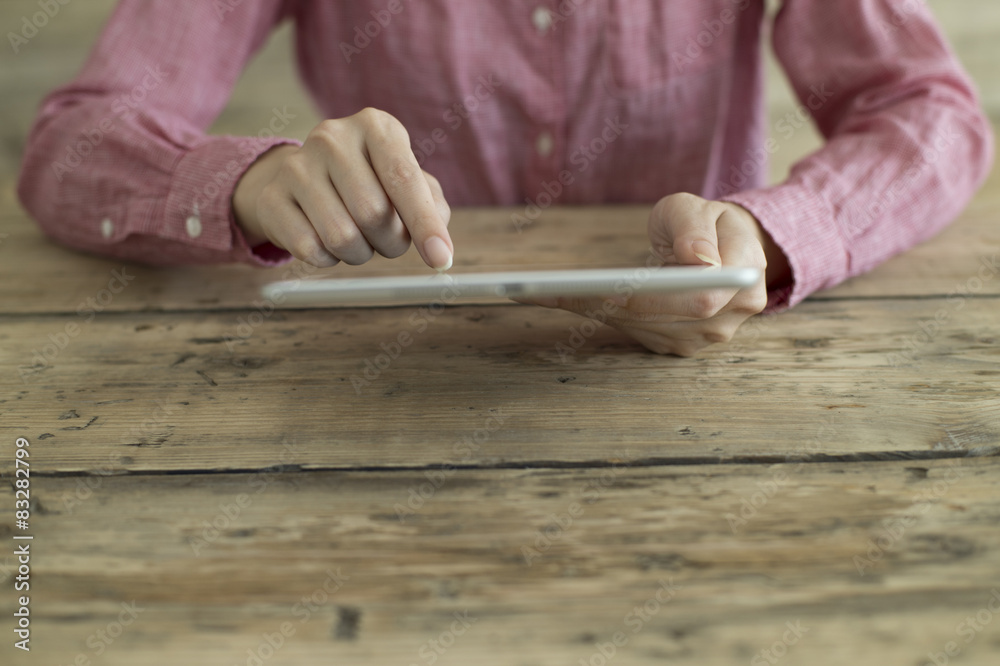 Woman is reading a book in the tablet