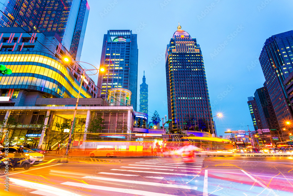 Traffic light trails in illuminated city