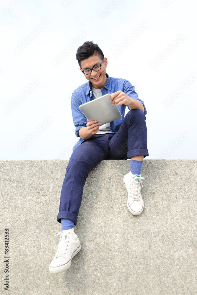 Happy man using digital tablet