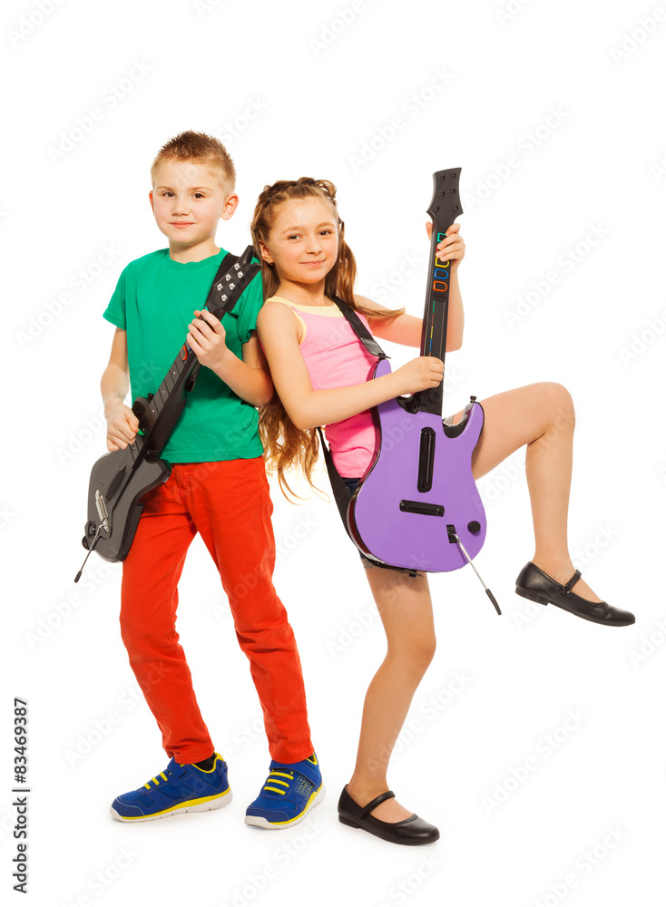 Boy and girl rock together playing on guitars