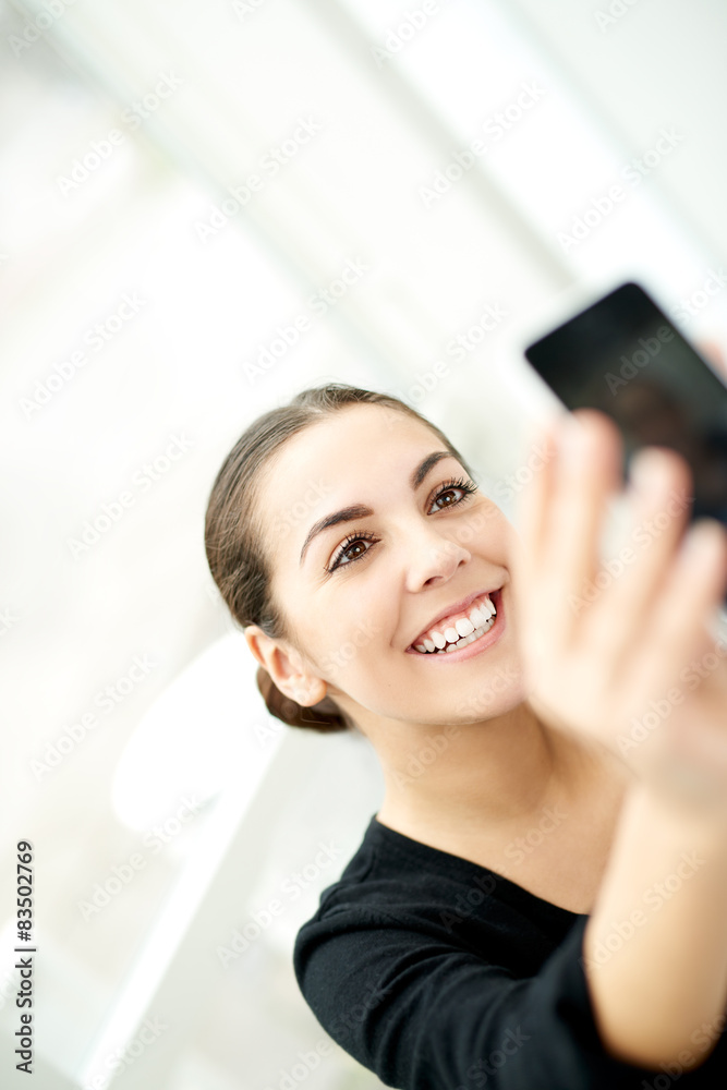 Happy woman taking a selfie on her mobile