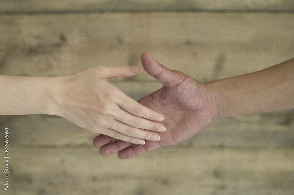 Men and women are trying to shake hands