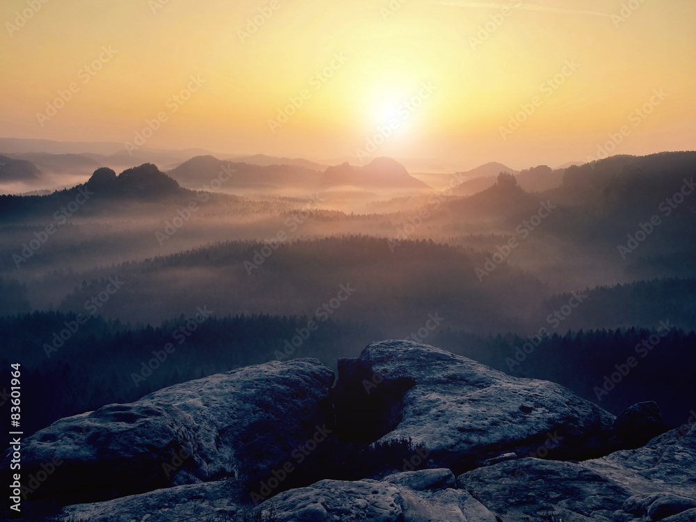 Cold misty autumn land in colorful shadows. Rocky fogy gulch