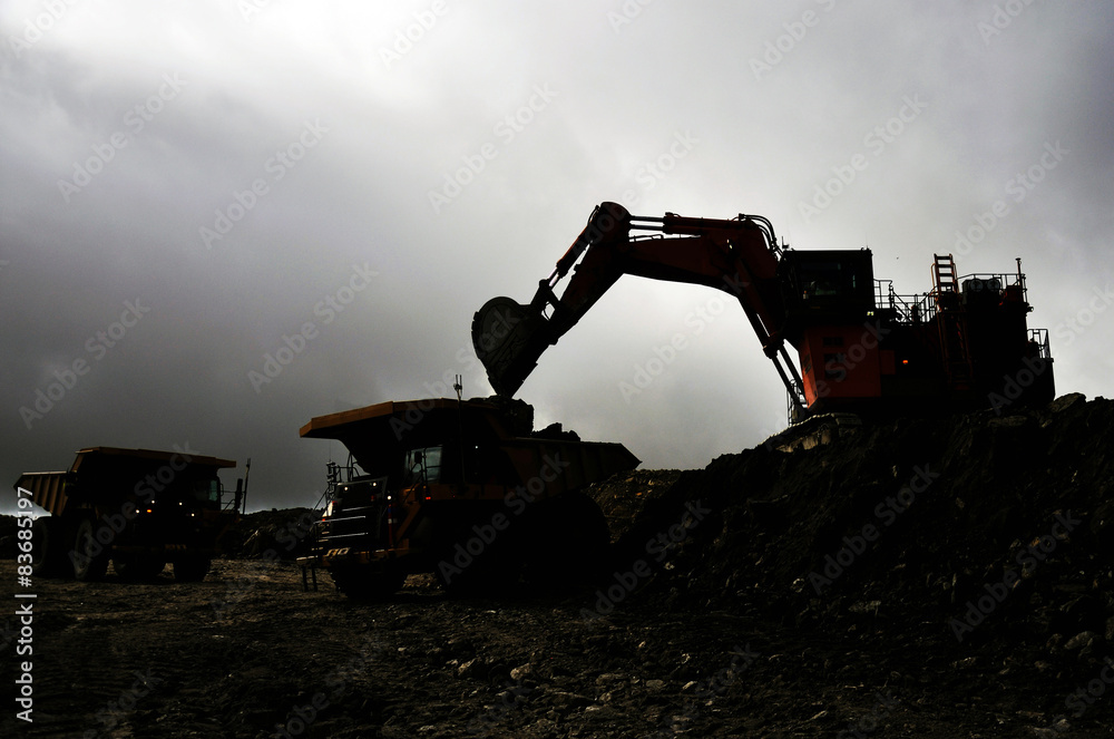 A 190 ton digger loads a truck with rock overburden